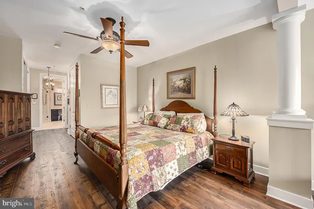 a bedroom with a bed and a chandelier