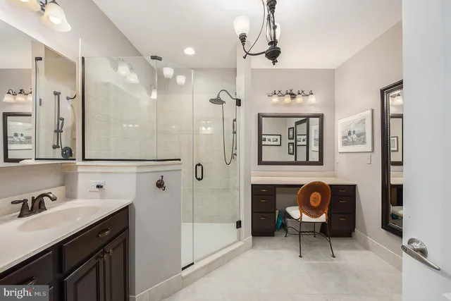 a spacious bathroom with a sink a vanity and a mirror