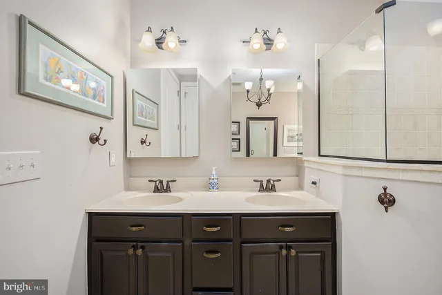 a bathroom with a double vanity sink mirror and