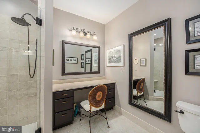 a bathroom with a toilet a sink and mirror
