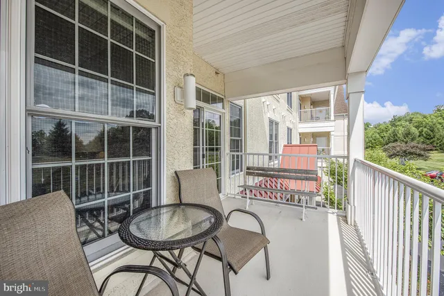 a view of a chair and table in the balcony