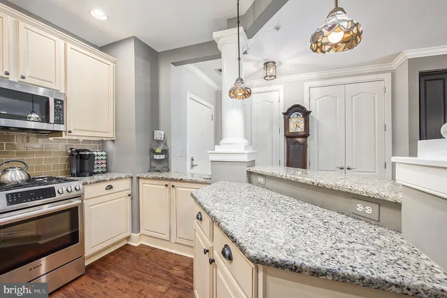 a large kitchen with granite countertop a stove and a sink