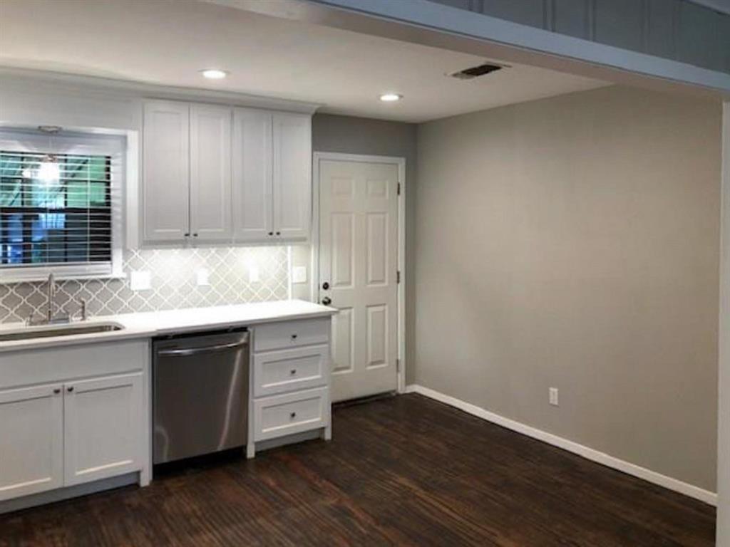 602 West 3rd Street Justin, TX 76247 - Photo 5 of 22 Kitchen featuring white shaker cabinetry, stainless steel dishwasher, white countertops, arabesque tile backsplash, and wood-finish flooring