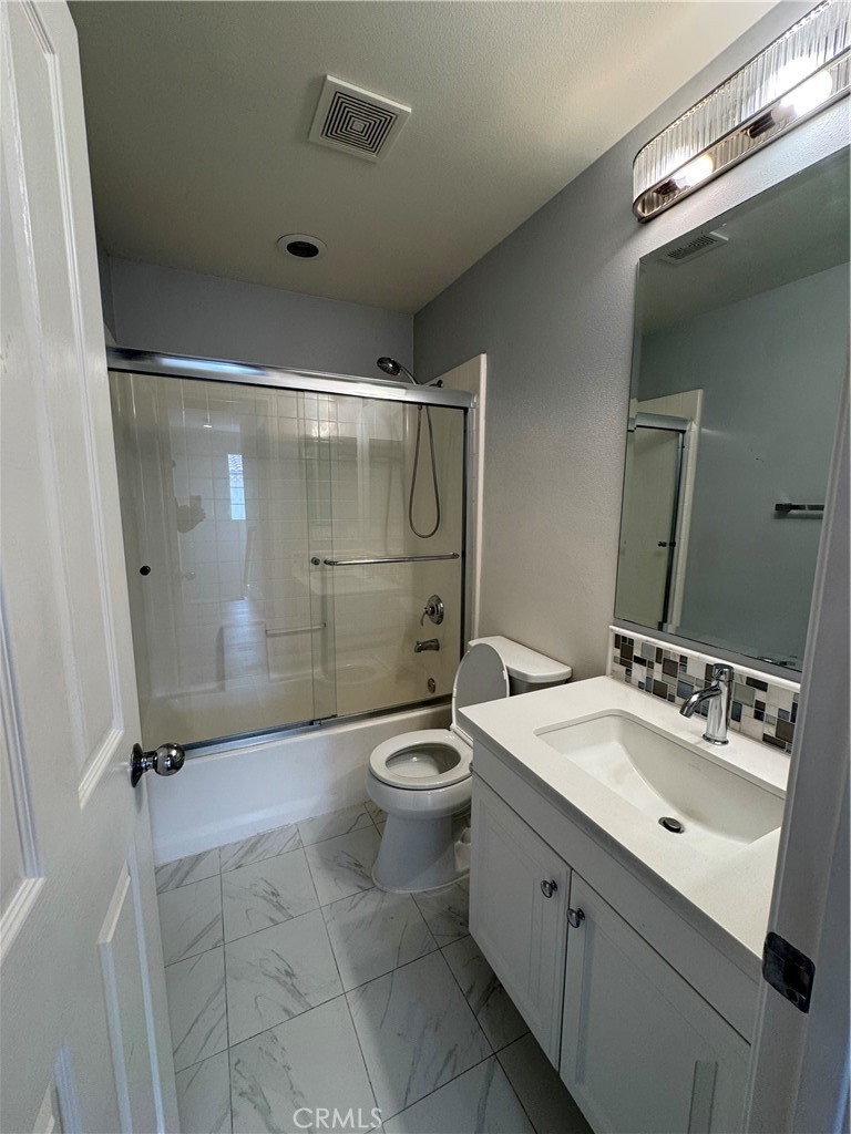 85 Canyoncrest Irvine, CA 92603 - Photo 12 of 12 a bathroom with a double vanity sink toilet and shower