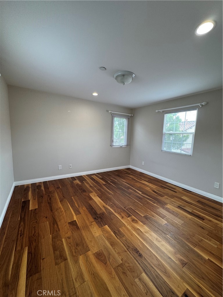 85 Canyoncrest Irvine, CA 92603 - Photo 10 of 12 wooden floor in an empty room with a window