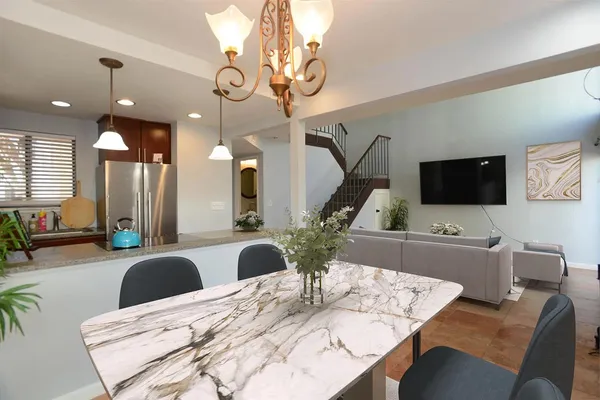 a large kitchen with a table and chairs