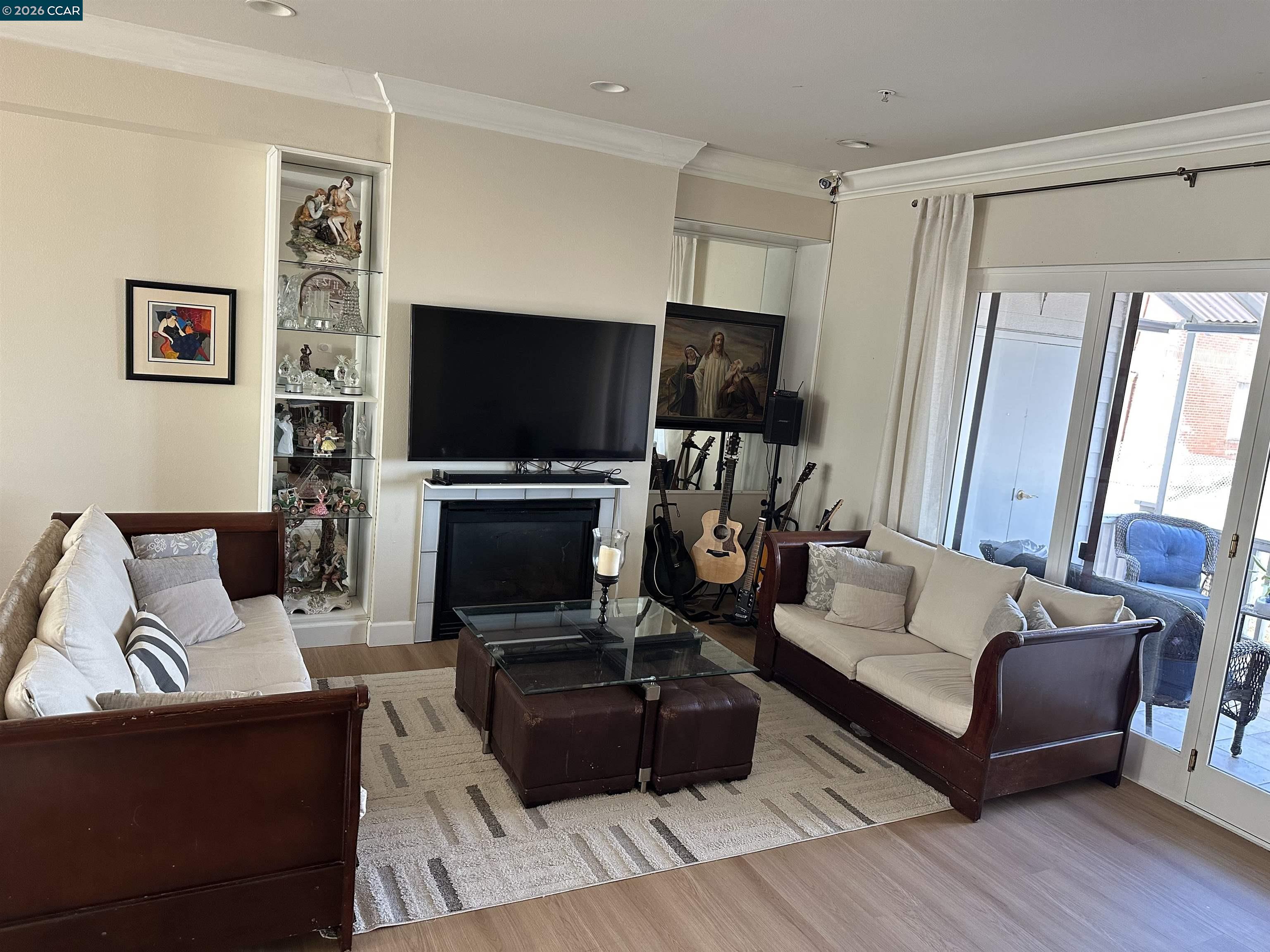 2144 Railroad Avenue Hercules, CA 94547 - Photo 11 of 29 a living room with furniture a flat screen tv and a fireplace