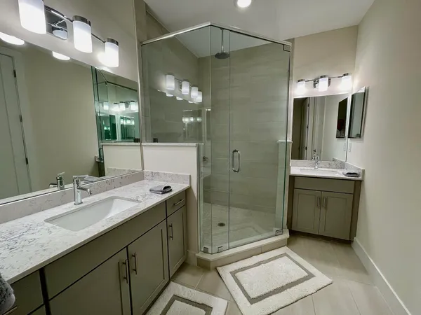 a bathroom with a shower sink and mirror