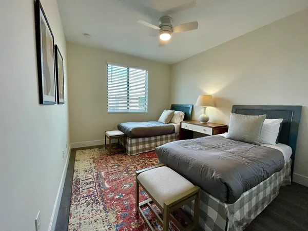a bedroom with two beds and a chandelier