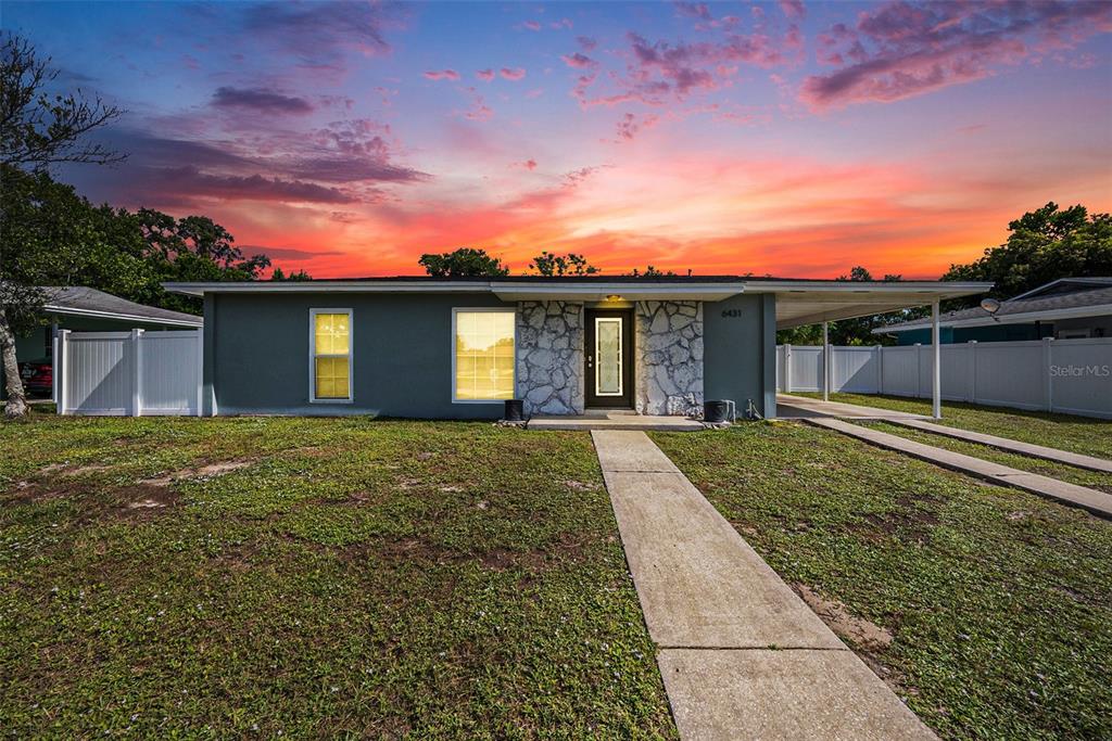 a view of a house with a yard