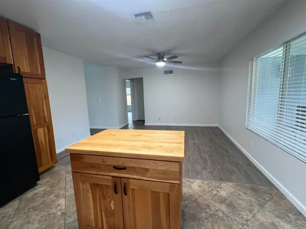 a view of a kitchen with a sink and a refrigerator