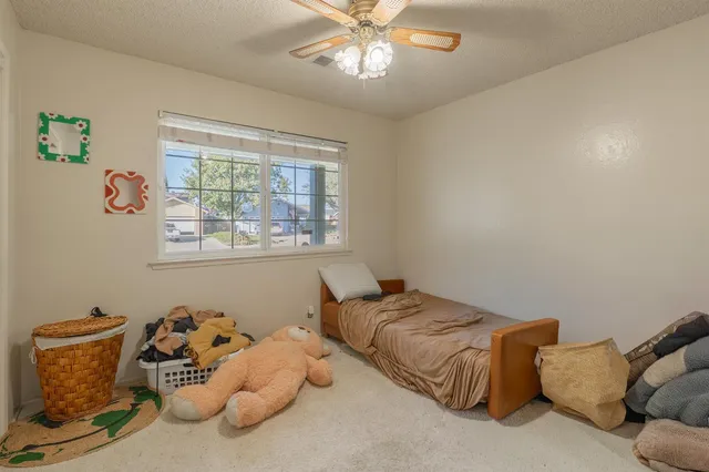 a bedroom with bed and a window