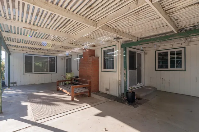 a patio with table and chairs