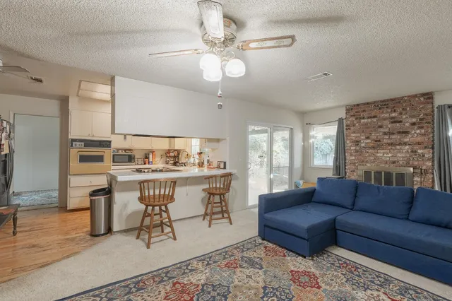 a living room with a couch and chandelier