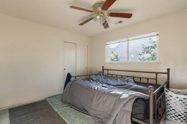 a bedroom with a bed and window