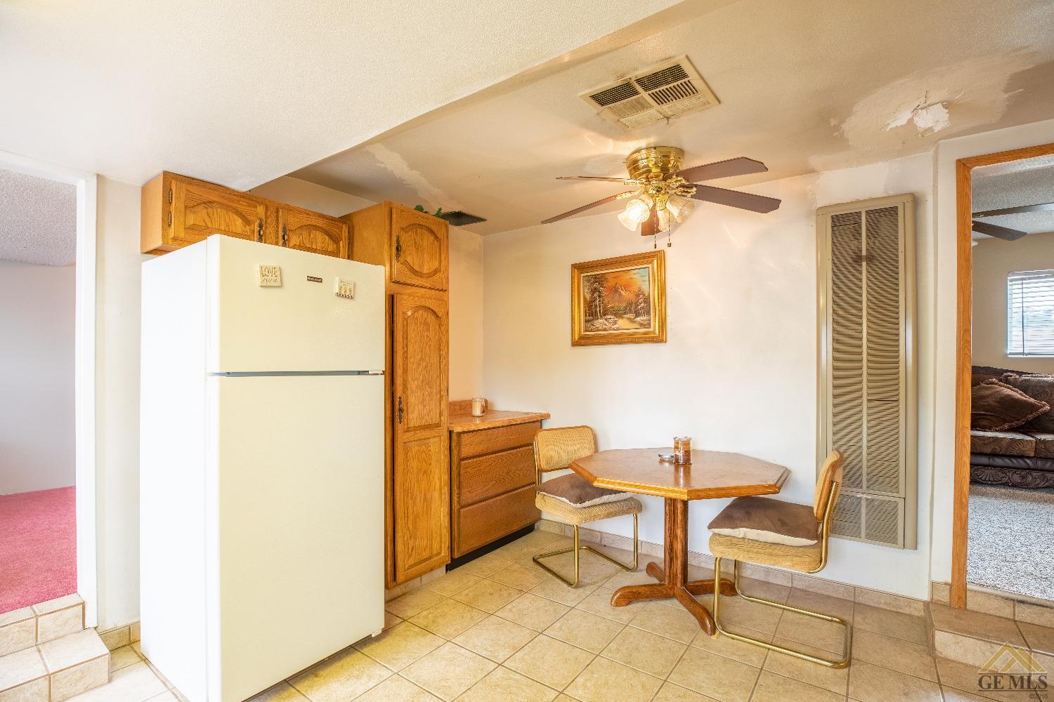 Undisclosed Address Taft, CA 93268 - Photo 20 of 24 a kitchen with stainless steel appliances a refrigerator and a table