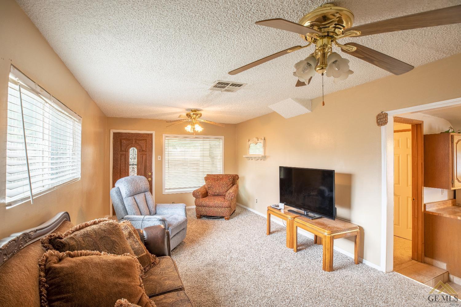 Undisclosed Address Taft, CA 93268 - Photo 7 of 24 a living room with furniture and a flat screen tv
