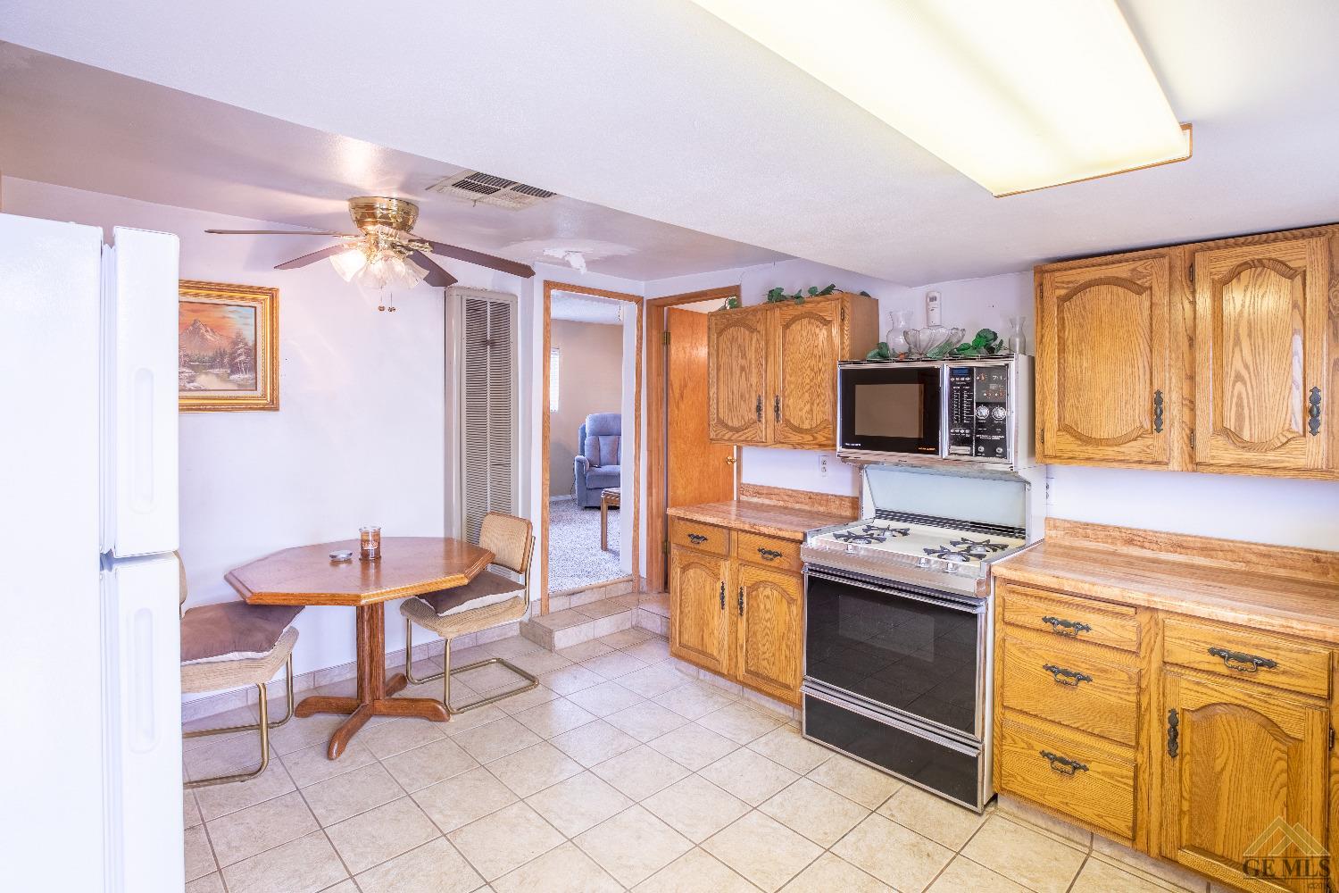 Undisclosed Address Taft, CA 93268 - Photo 8 of 24 a kitchen with stainless steel appliances kitchen island granite countertop a sink and cabinets