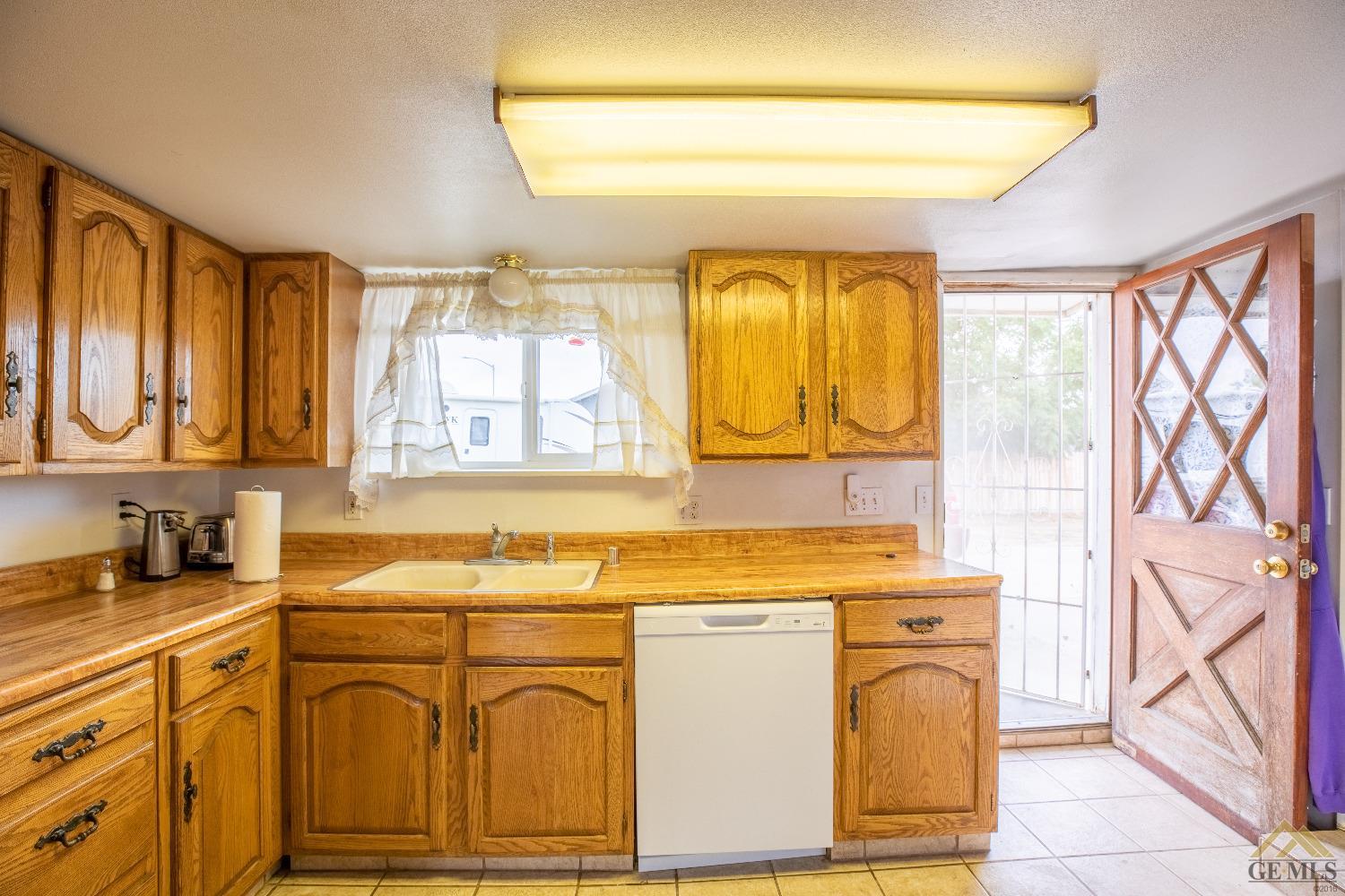 Undisclosed Address Taft, CA 93268 - Photo 10 of 24 a kitchen with cabinets appliances and a counter top space