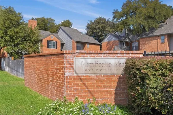 a front view of a house with plants