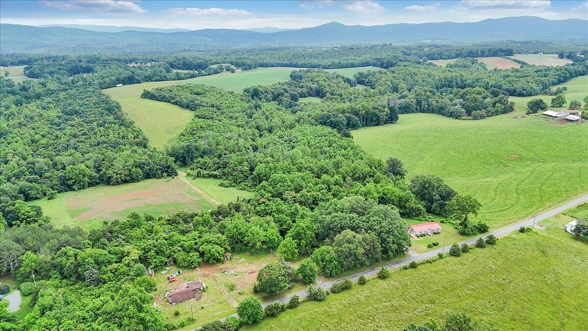 a view of a lush green hillside and houses