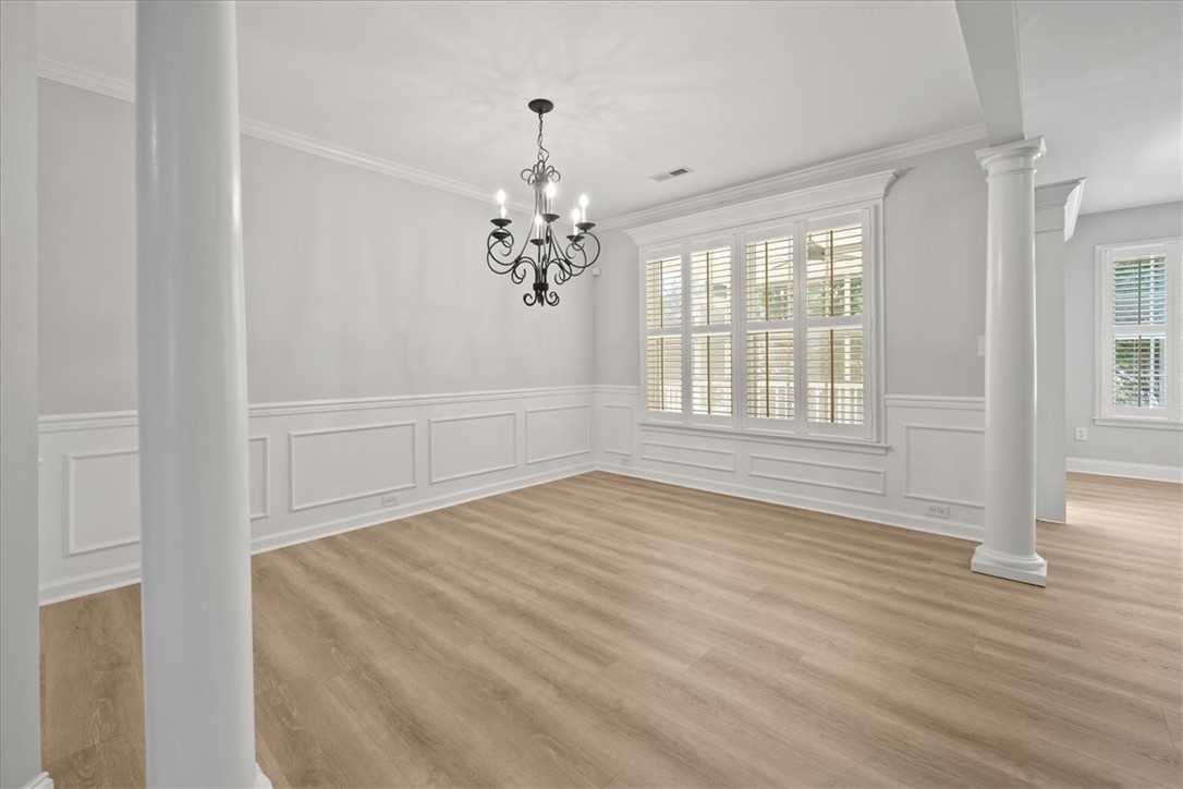 100 Shipyard Circle Anderson, SC 29621 - Photo 8 of 40 This bright and airy room features elegant wainscoting and durable flooring, creating a refined atmosphere.