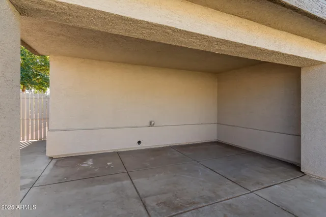a backyard of a house with table and chairs