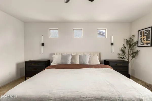 a bedroom with a bed and a potted plant