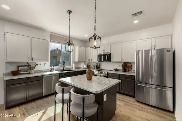 a kitchen with a refrigerator a sink and a stove