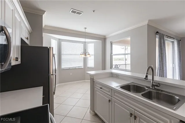 a kitchen with stainless steel appliances a sink stove and refrigerator