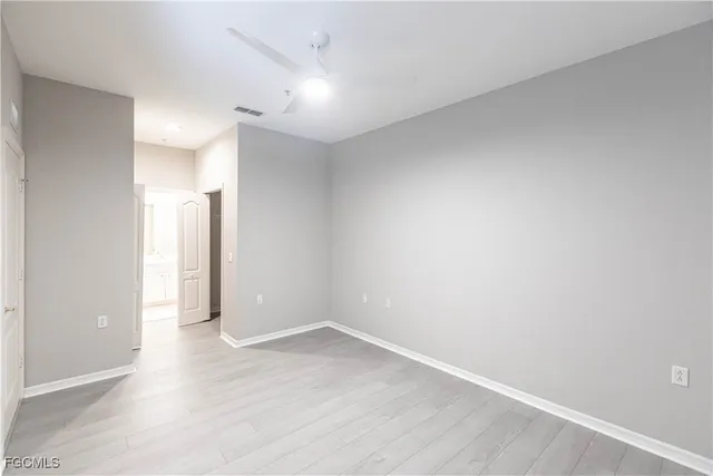 an empty room with wooden floor and closet