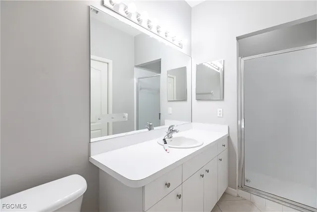 a bathroom with a shower a toilet and a sink