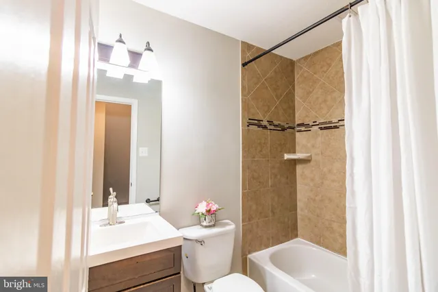 a bathroom with a shower and a bath tub