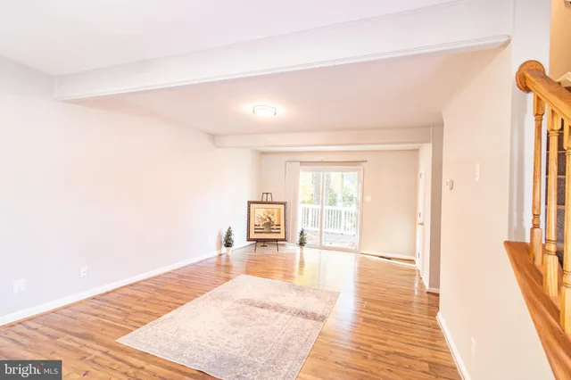 a big room with wooden floor and windows
