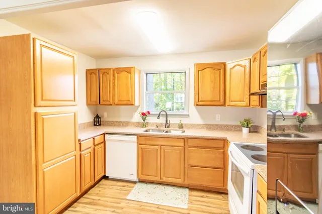 a kitchen with a sink stove top oven and cabinets
