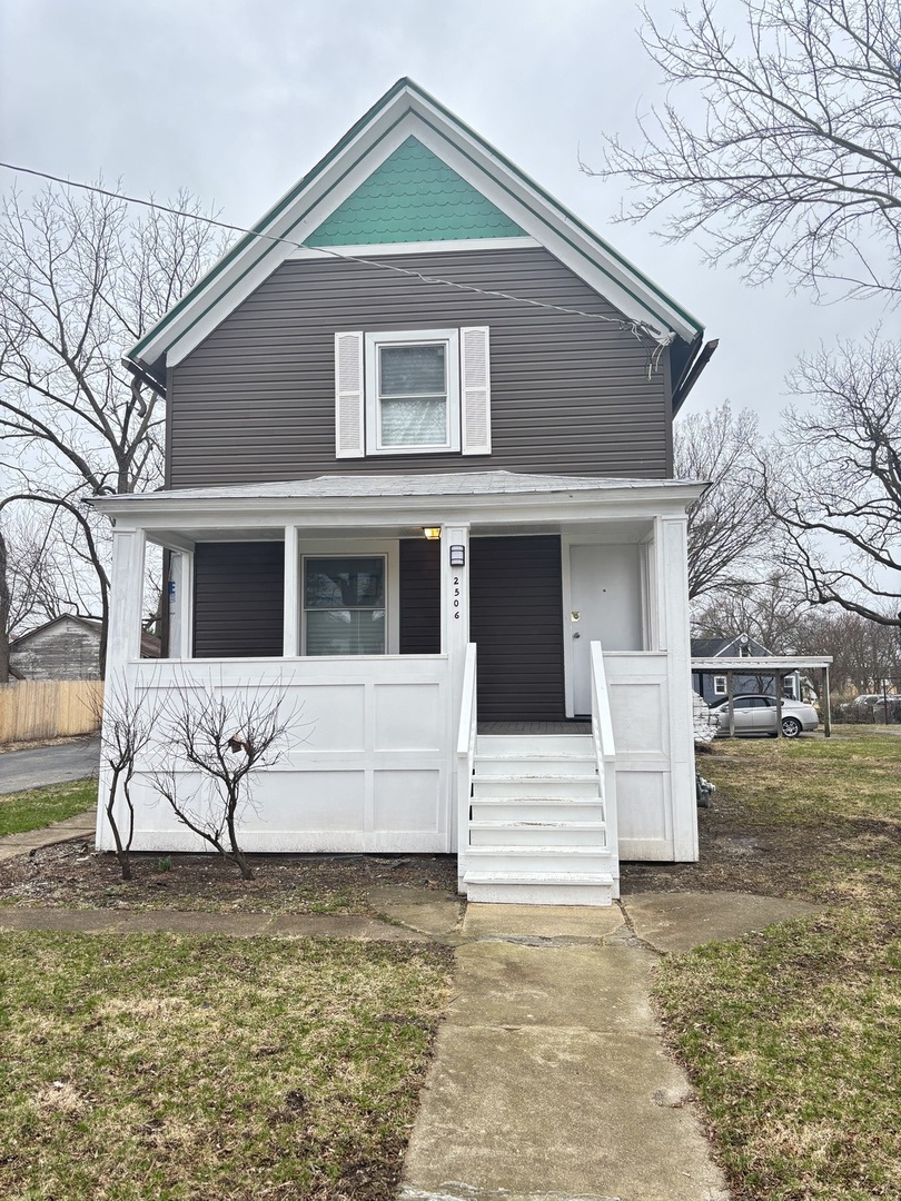 2506 Ash Street, Unit 1 Chicago Heights, IL 60411 - Photo 1 of 7 a front view of a house with garage