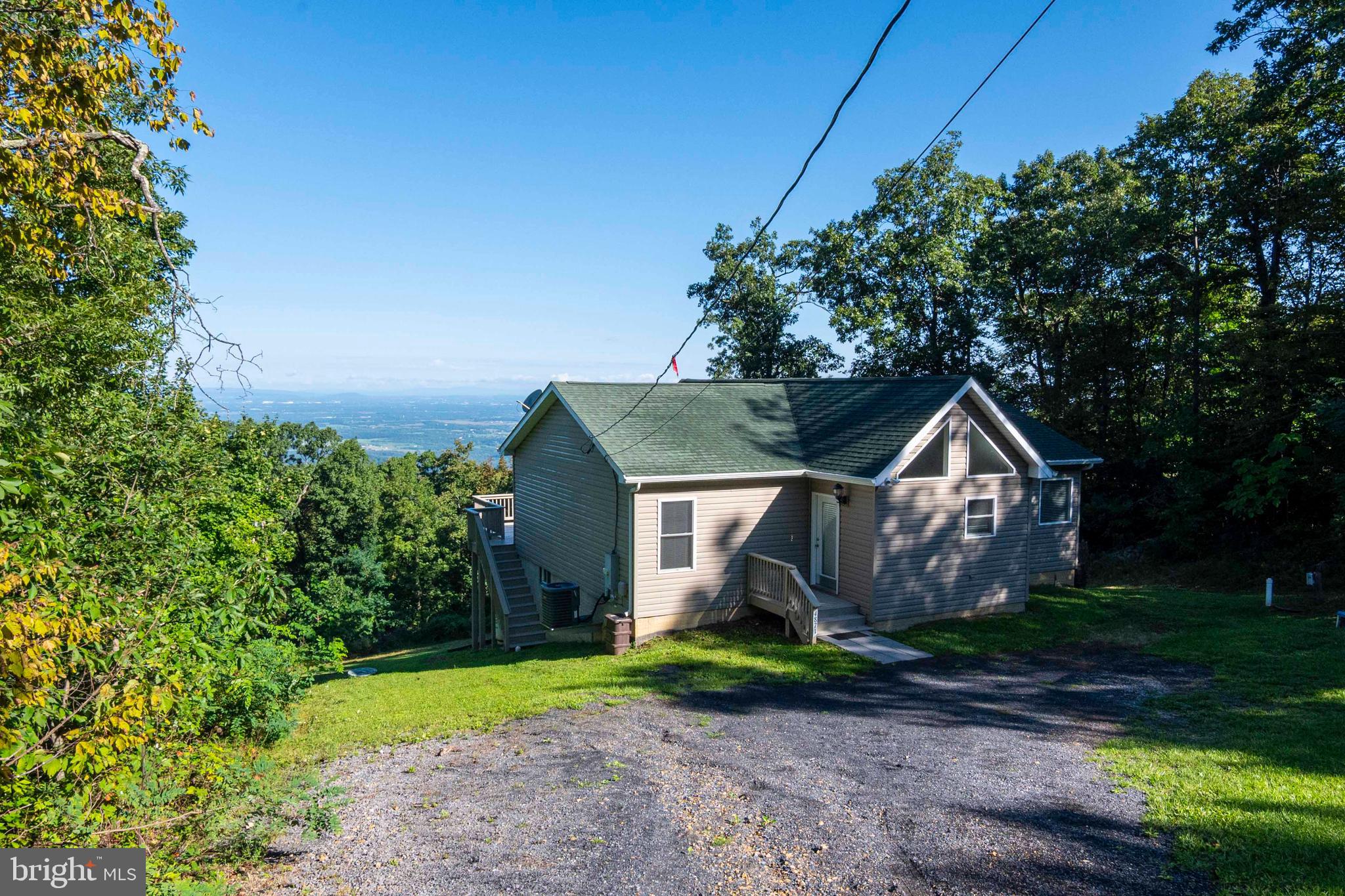 4871 Blue Mountain Road Linden, VA 22642 - Photo 12 of 73 a view of a big house with a big yard and large trees