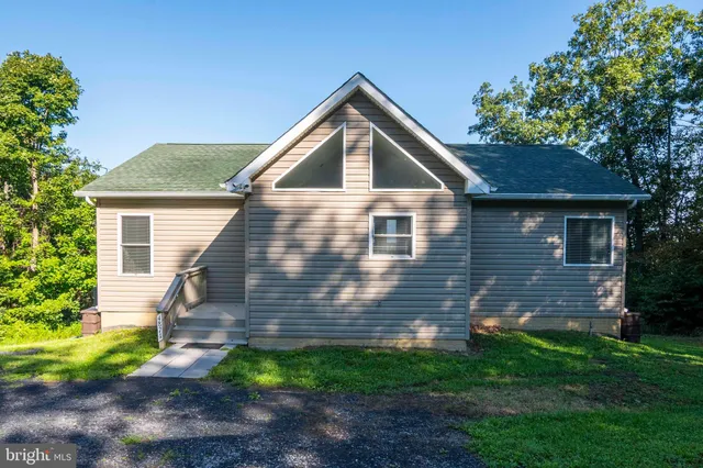 a balcony with wooden floor and outdoor seating