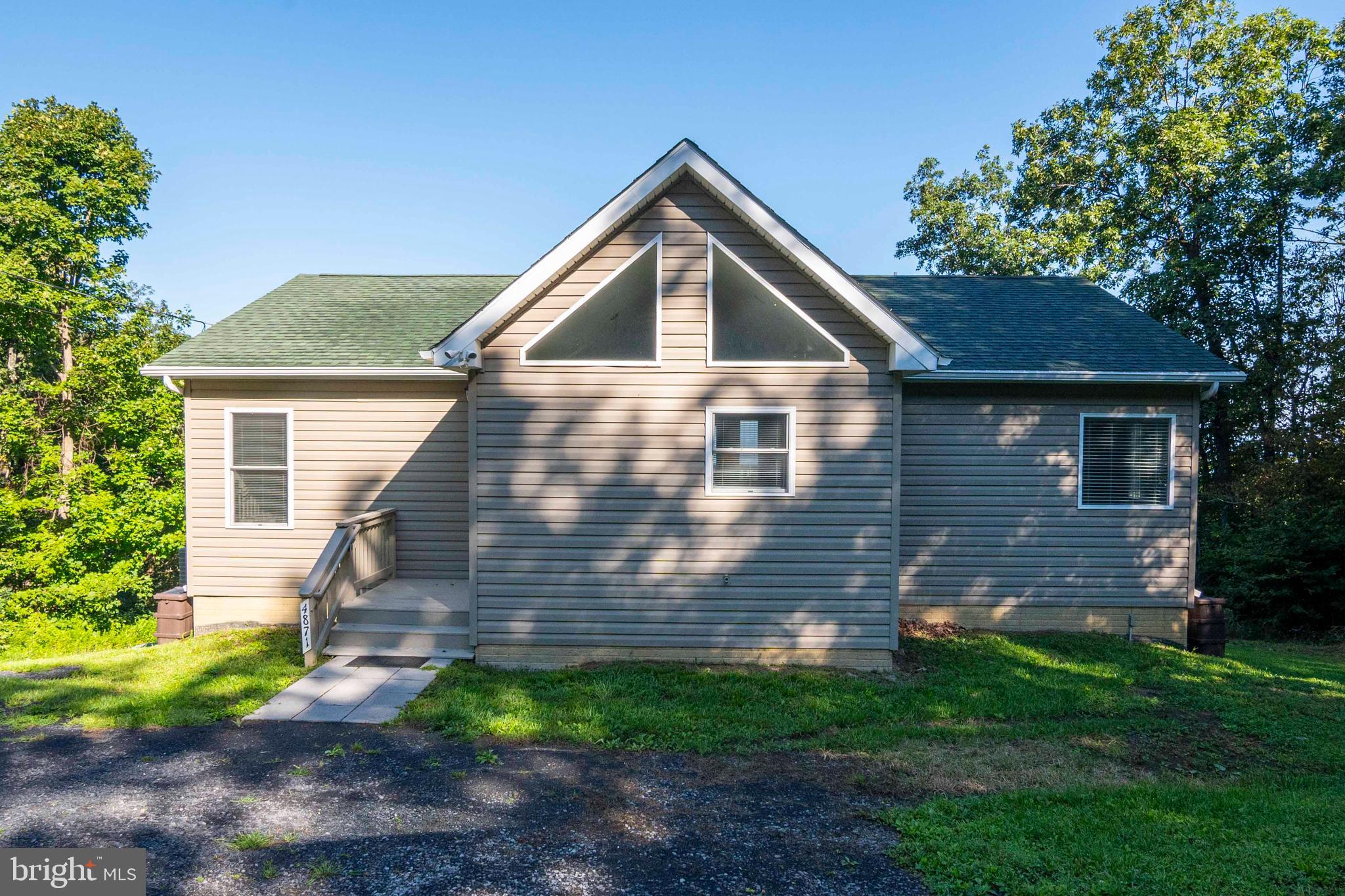 4871 Blue Mountain Road Linden, VA 22642 - Photo 14 of 73 a front view of a house with garden