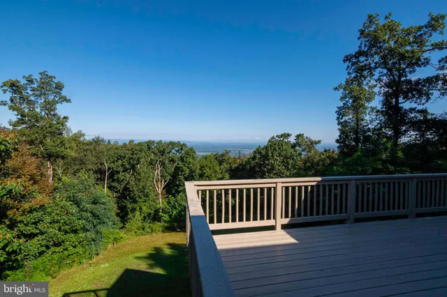 a house view with a garden and deck