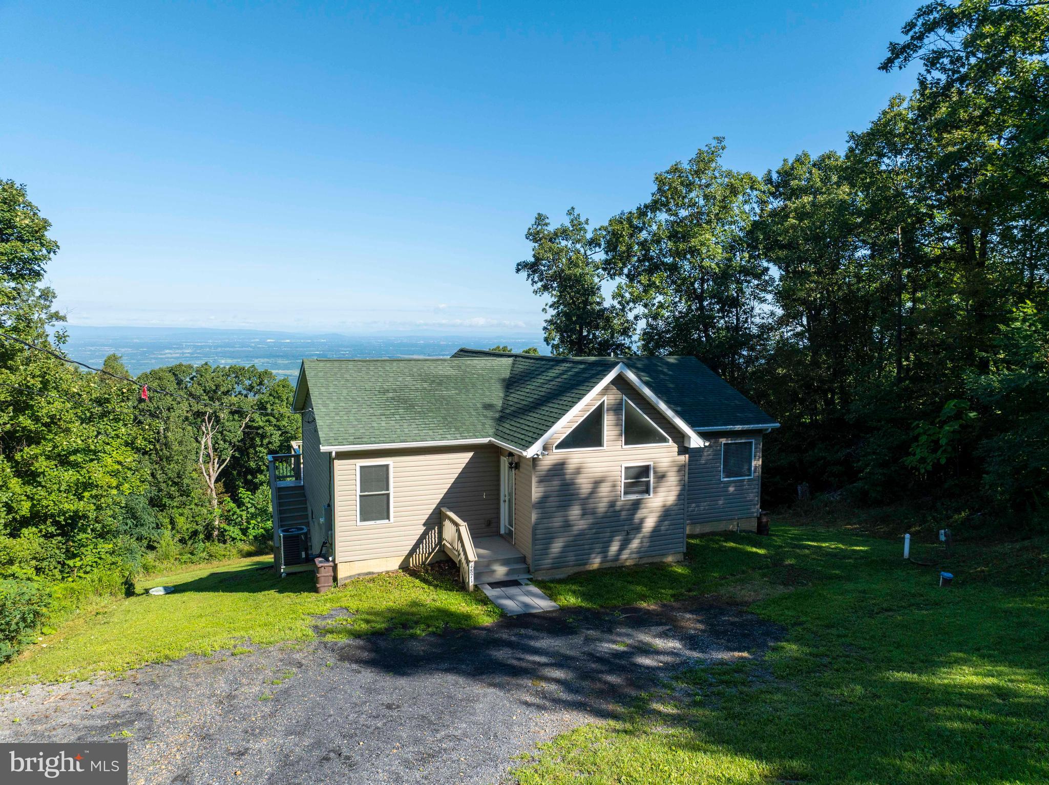 4871 Blue Mountain Road Linden, VA 22642 - Photo 3 of 73 a front view of a house with a yard