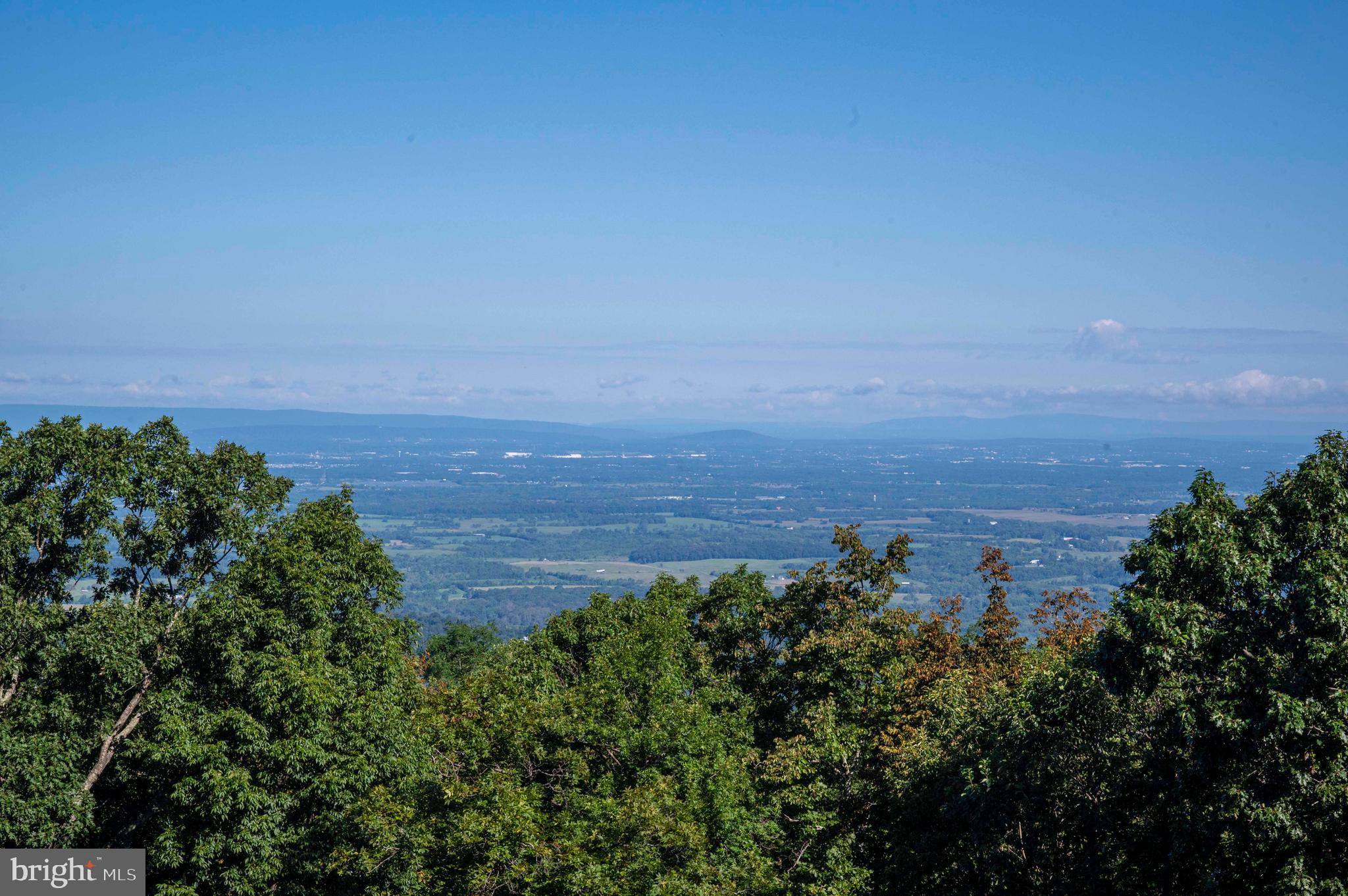 4871 Blue Mountain Road Linden, VA 22642 - Photo 31 of 73 a view of a lake with a building in the background