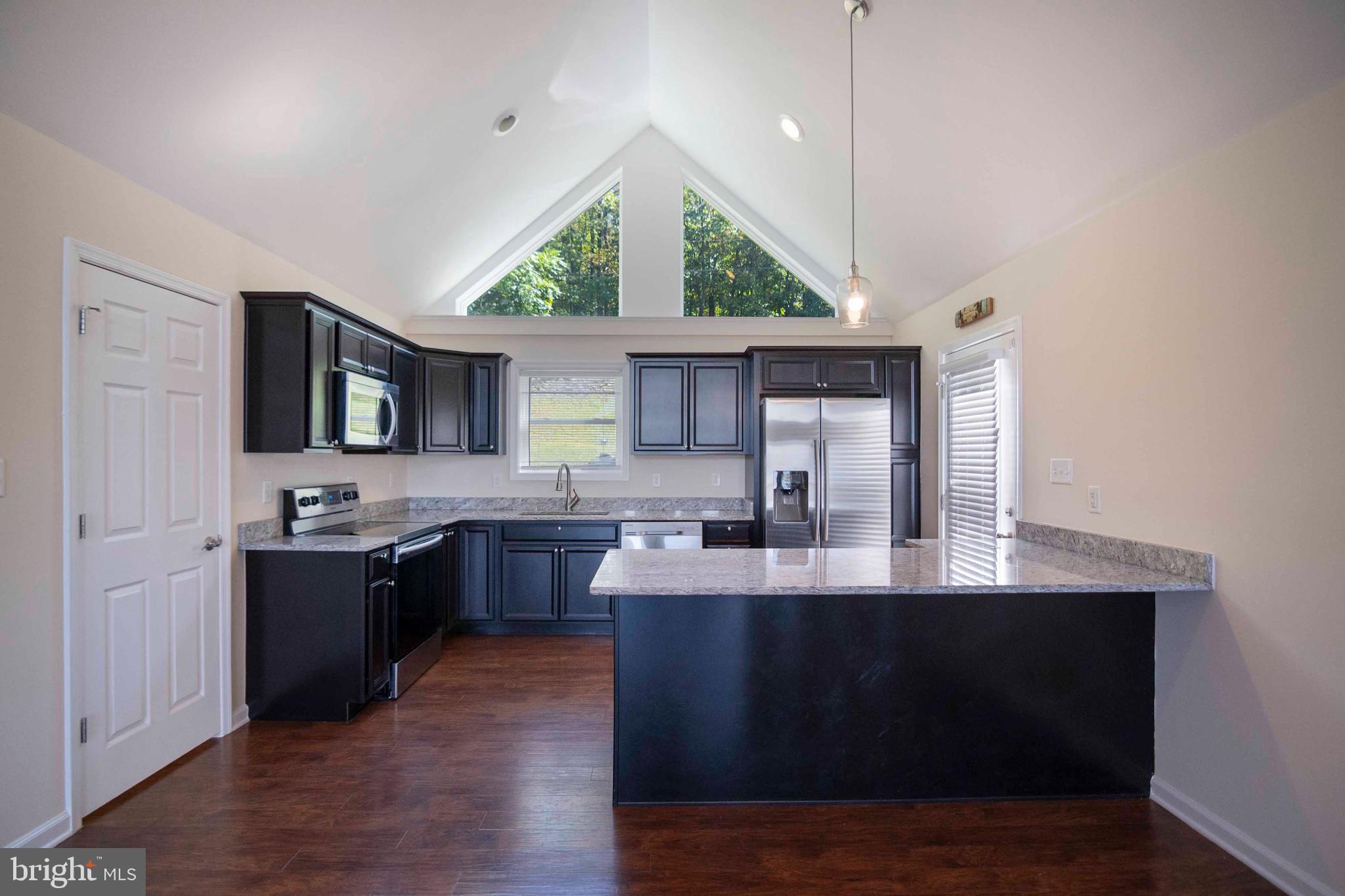 4871 Blue Mountain Road Linden, VA 22642 - Photo 33 of 73 a kitchen with kitchen island granite countertop a sink appliances and cabinets