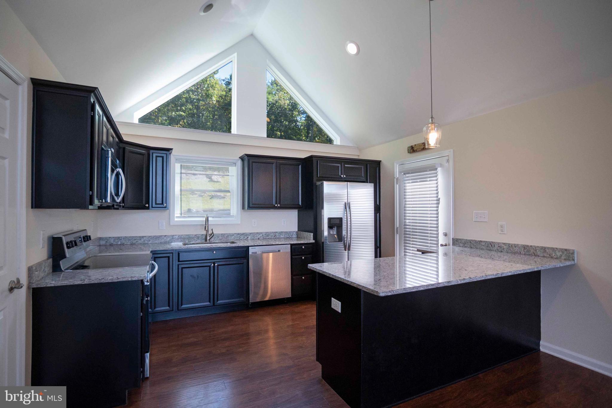 4871 Blue Mountain Road Linden, VA 22642 - Photo 34 of 73 a kitchen with granite countertop a sink and cabinets