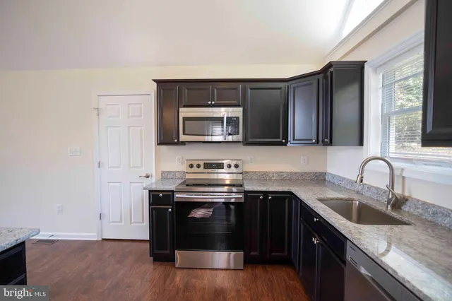 a bath tub sitting in a bathroom next to a window