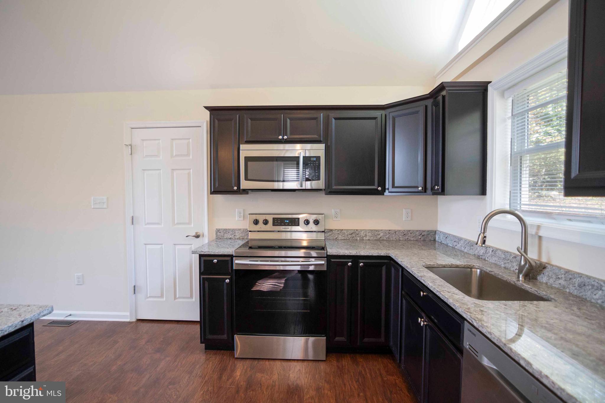 4871 Blue Mountain Road Linden, VA 22642 - Photo 36 of 73 a kitchen with stainless steel appliances granite countertop a sink stove and microwave