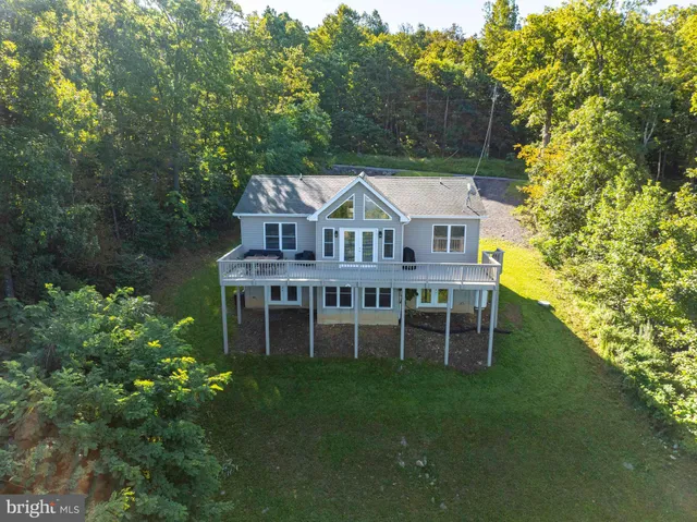 a aerial view of a house with pool and a yard