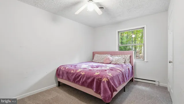 a bed sitting in a bedroom next to a window