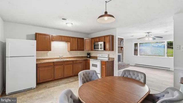 a kitchen with stainless steel appliances granite countertop a sink refrigerator stove microwave and cabinets