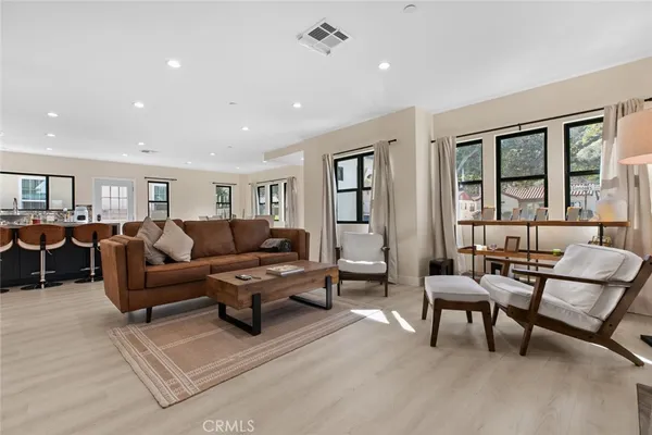 a living room with furniture and kitchen view